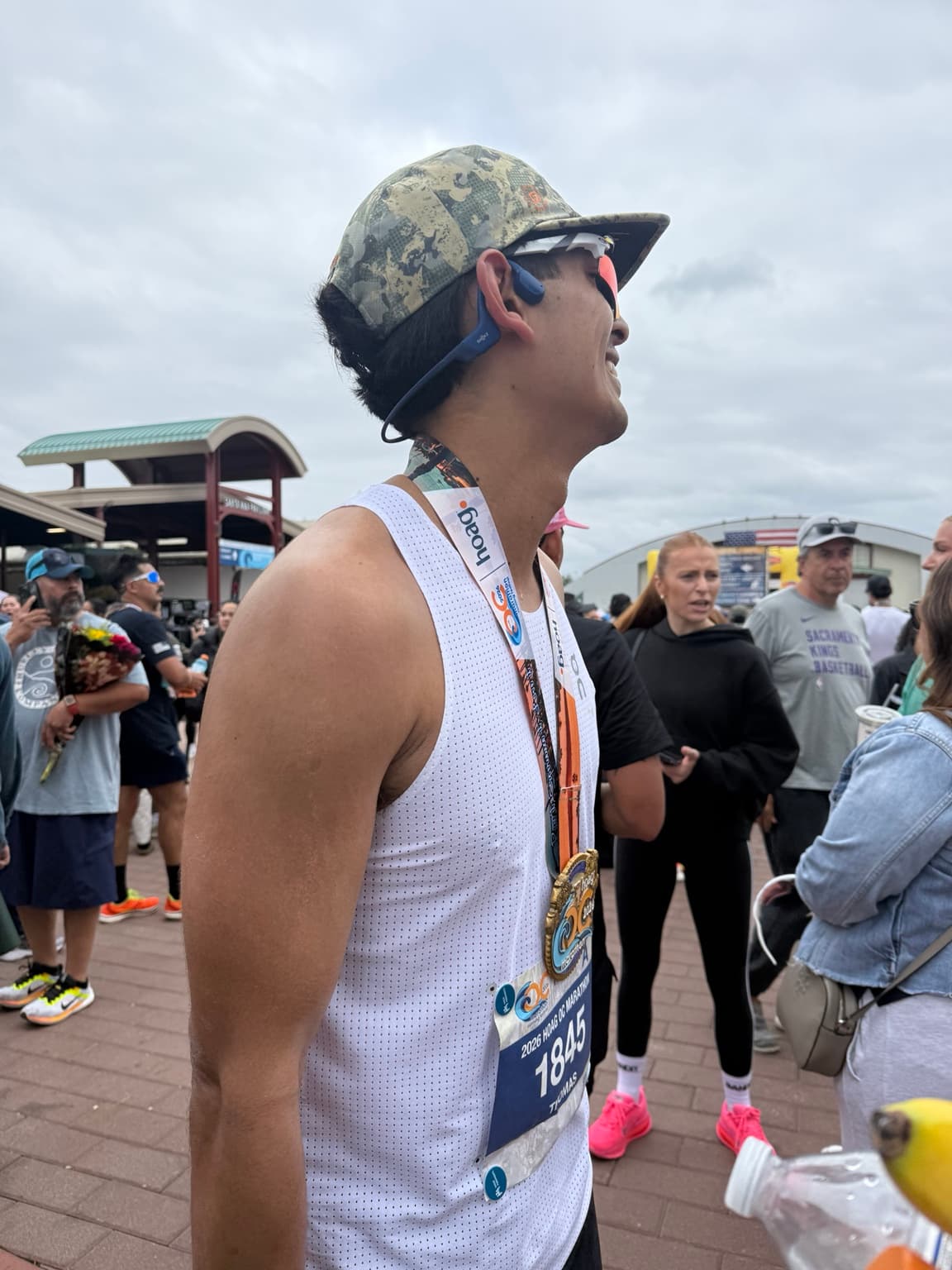 Tom Van Schoor wearing his medal after finishing the 2026 OC Marathon.